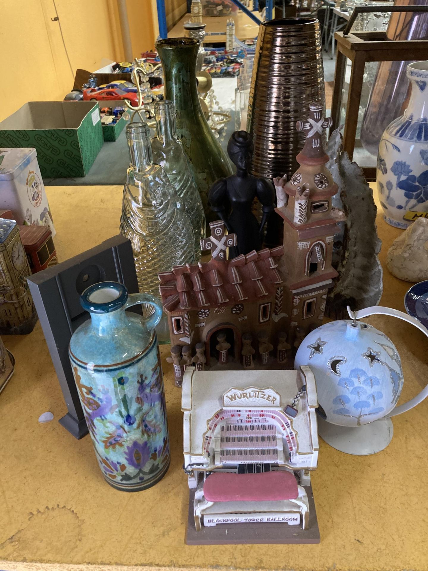 A MIXED LOT TO INCLUDE GLASS FISH SHAPED BOTTLES, VASES, A TERACOTTA CHURCH, VASES, LADY FIGURE, ETC