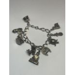 A SILVER CHARM BRACELET WITH NINE VARIOUS CHARMS