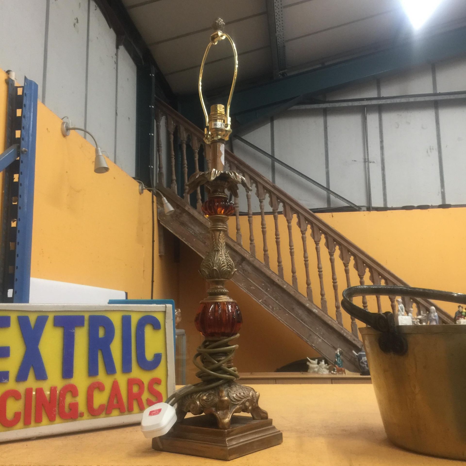 A VINTAGE BRASS AND RED GLASS TABLE LAMP