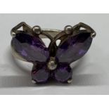 A SILVER RING WITH PURPLE STONES IN A BUTTERFLY DESIGN SIZE M IN A PRESENTATION BOX