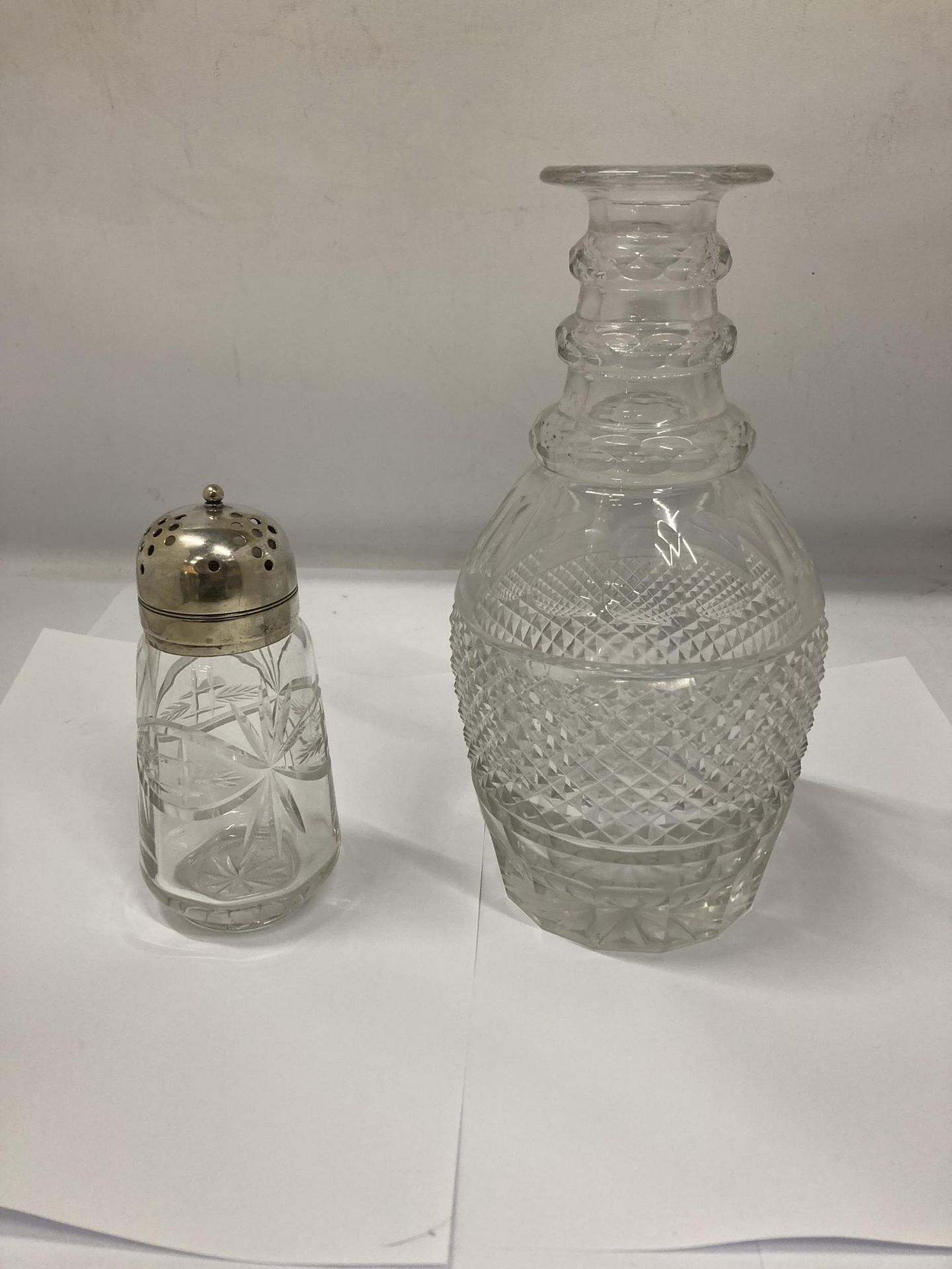 A GLASS DECANTER AND A SUGAR SIFTER WITH PLATED LID