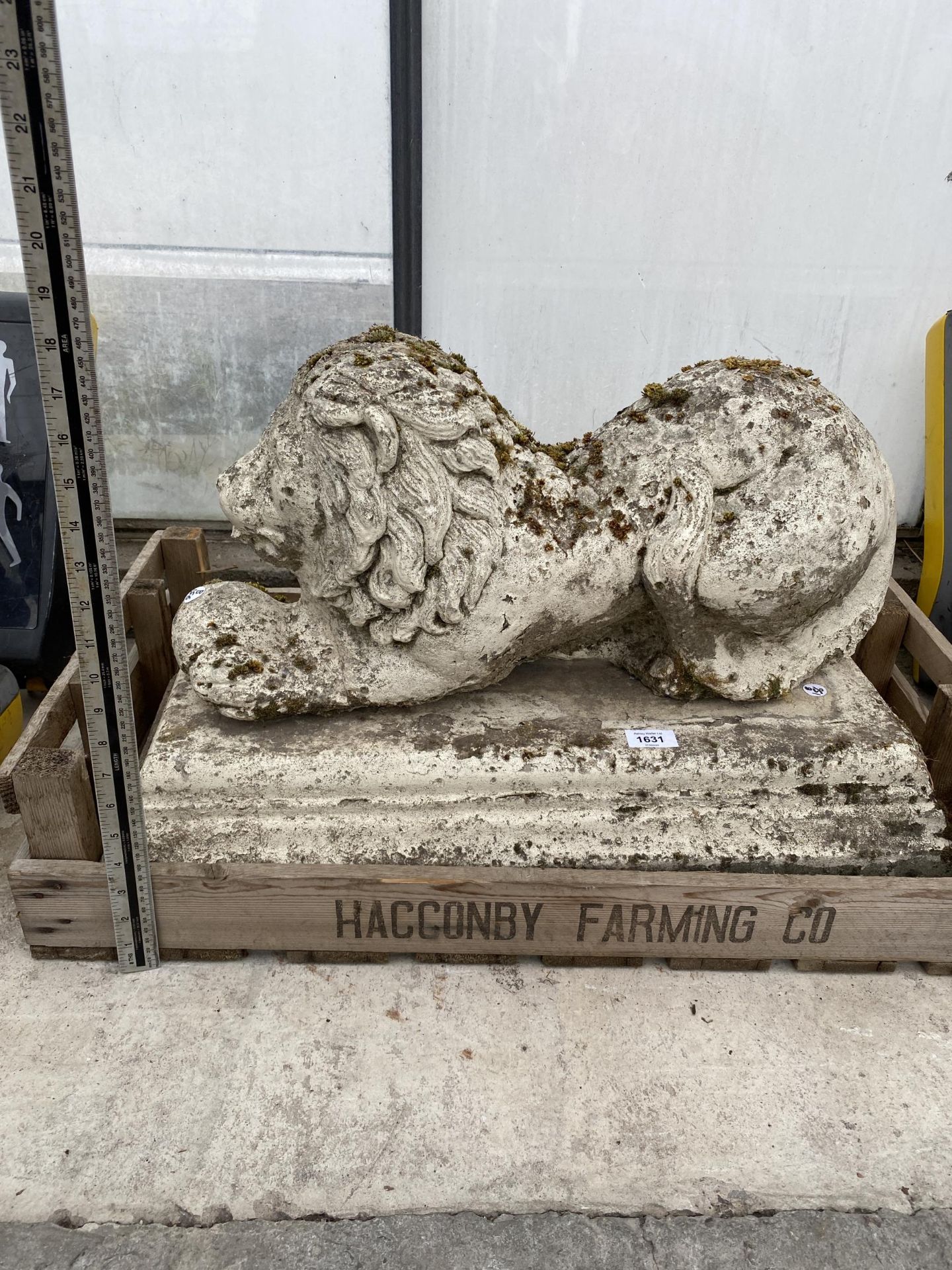 A RECONSTITUTED STONE LION GARDEN FIGURE WITH PLINTH BASE
