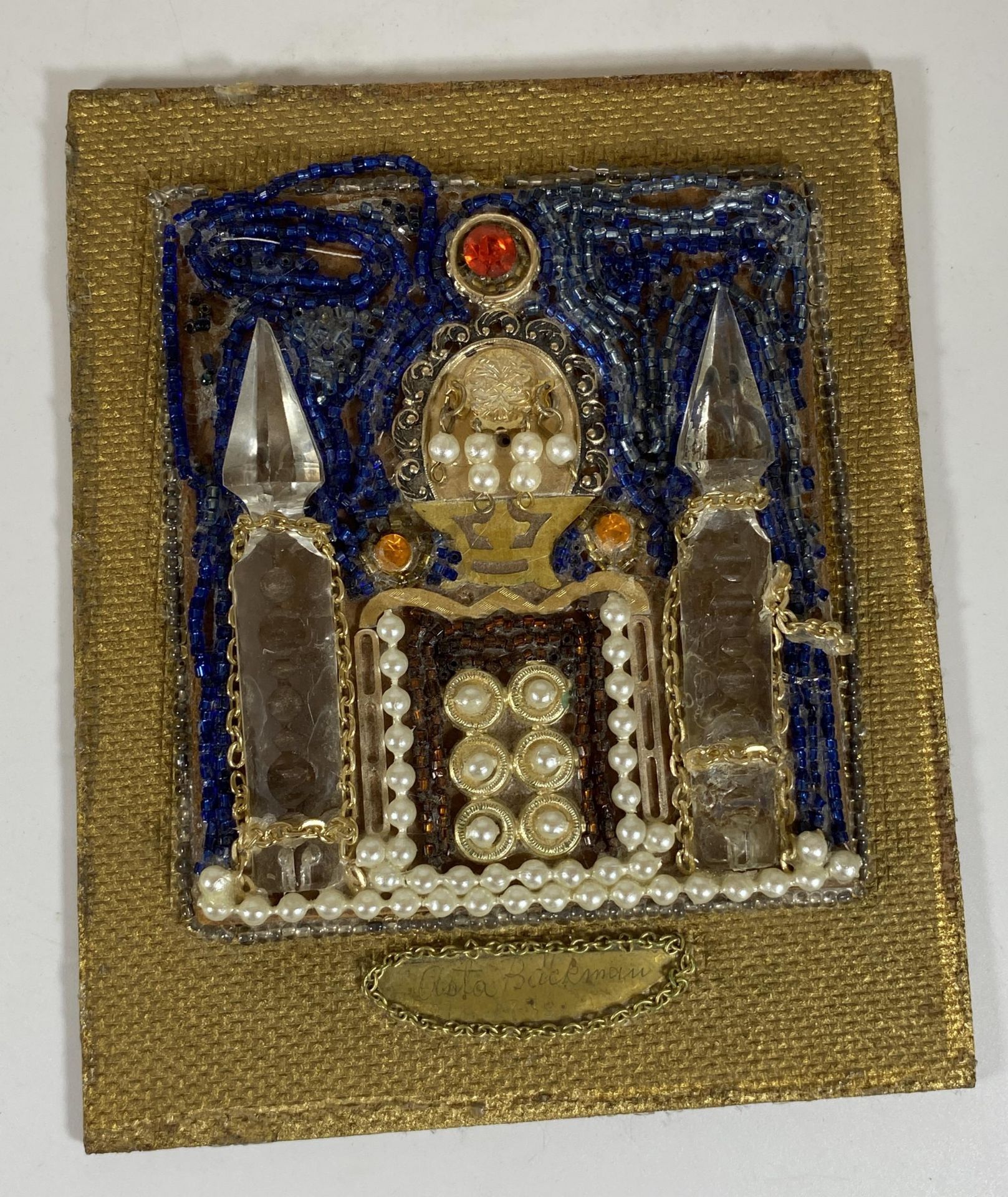 AN UNSUSUAL SMALL PICTURE BEAD MONTAGE OF A RELIGIOUS BUILDING, SIGNED AND DATED 1916, PAPER LABEL