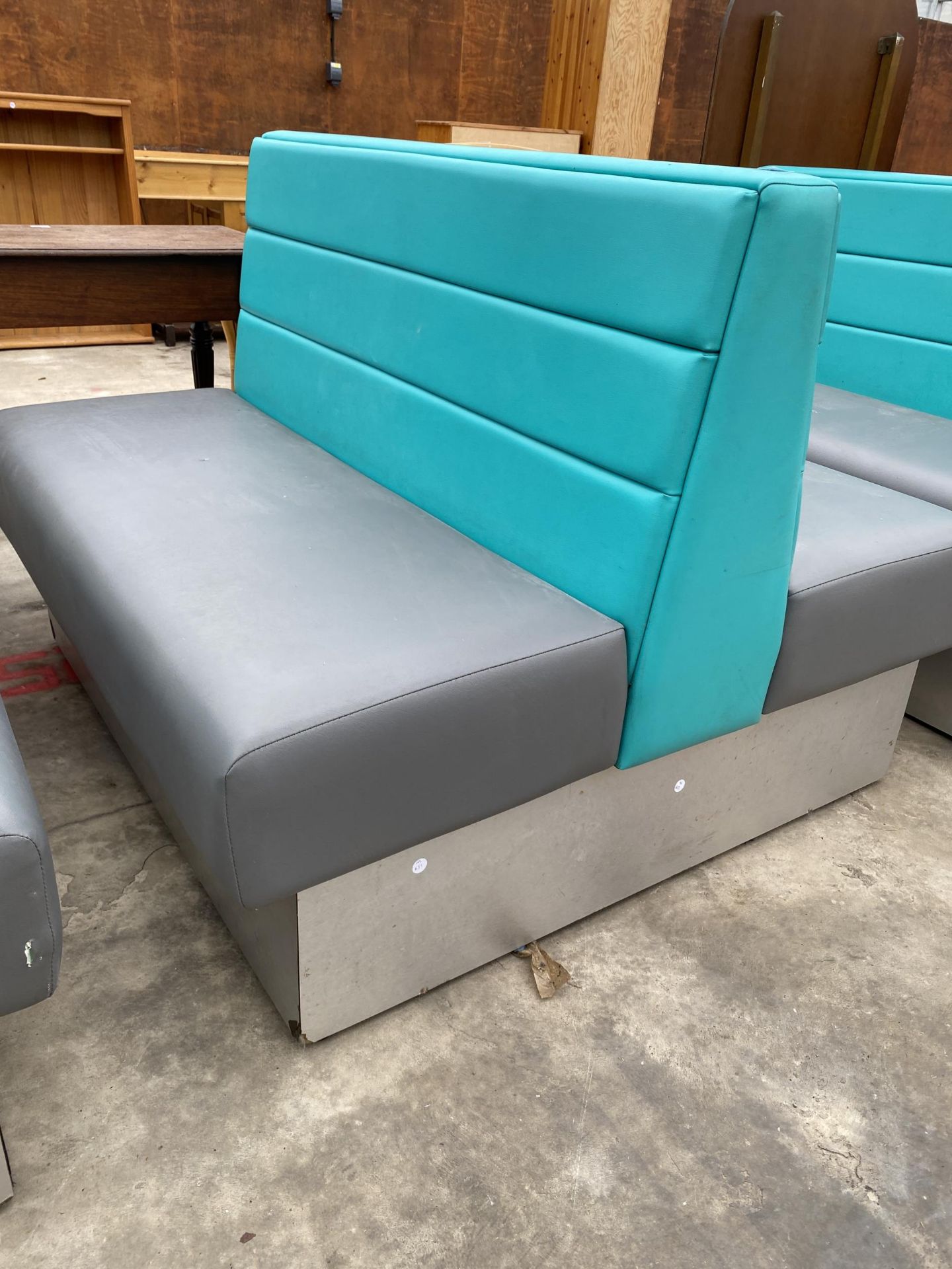 A MODERN DOUBLE SIDED BOOTH SEATING IN TURQUOISE AND GREY