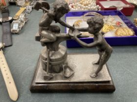 A PEWTER FIGURE OF A BLACKSMITH ON BASE