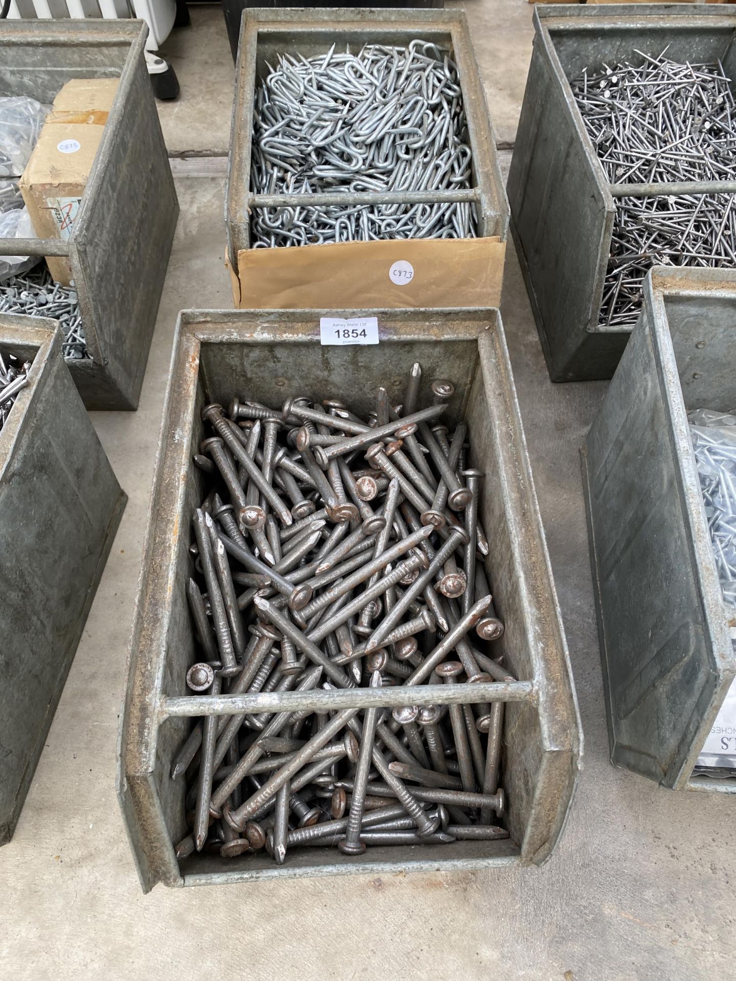 A LARGE ASSORTMENT OF NAILS AND FENCING STAPLES