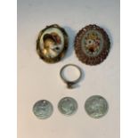 SIX ITEMS TO INCLUDE THREE DRILLED SILVER COINS, A SILVER RING AND TWO BROOCHES