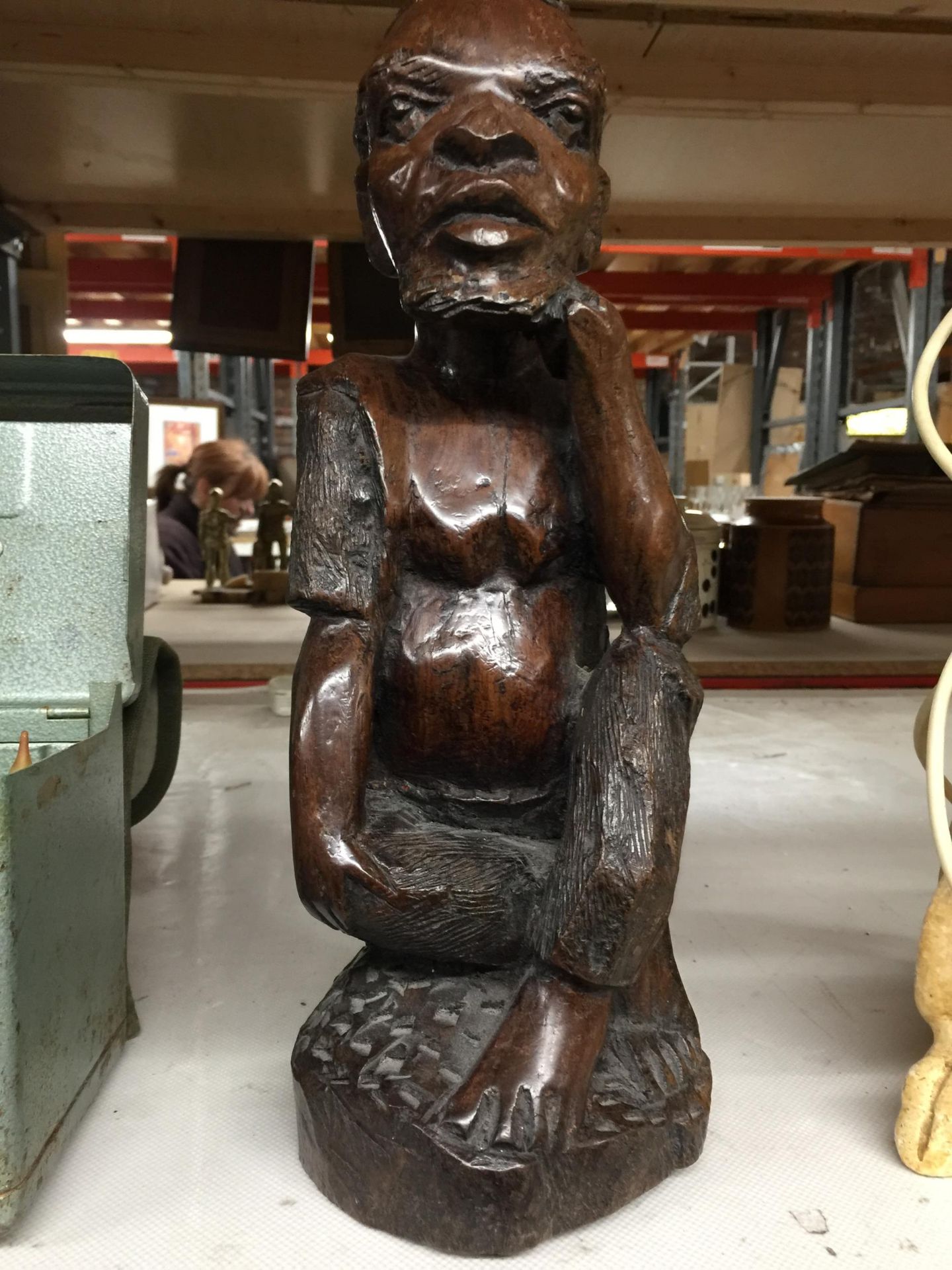 A HEAVY WOODEN CARVED TRIBAL STYLE FIGURE, HEIGHT 34CM