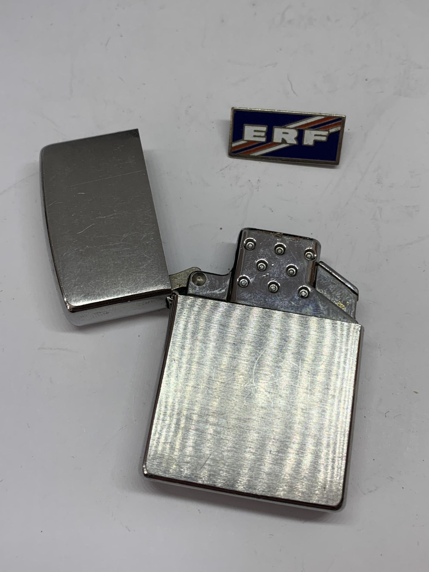 A MADE IN USA ZIPPO LIGHTER AND AN ENAMEL ERF BADGE - Image 2 of 3