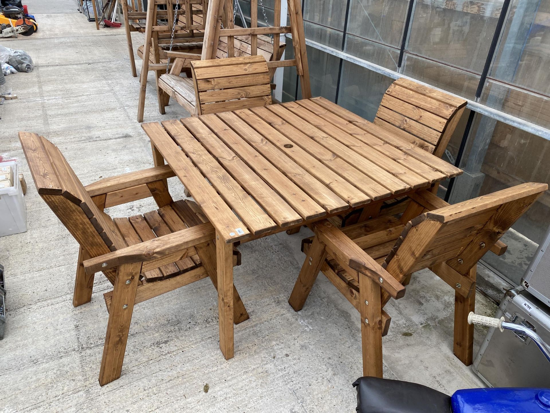 AN AS NEW EX DISPLAY CHARLES TAYLOR PATIO SET COMPRISING OF A SQUARE TABLE AND FOUR CHAIRS