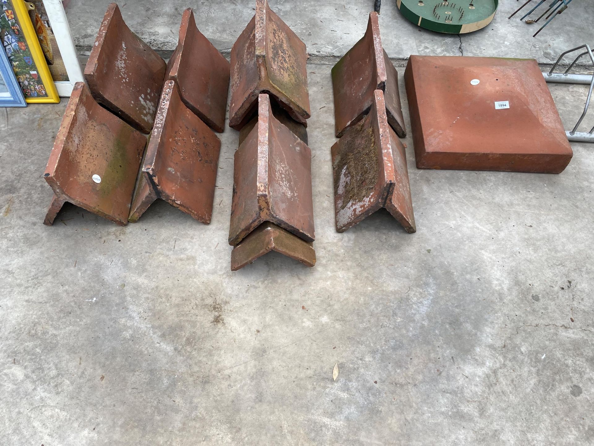 A TERACOTTA GATE POST TOPPER AND AN ASSORTMENT OF ROOF RIDGES