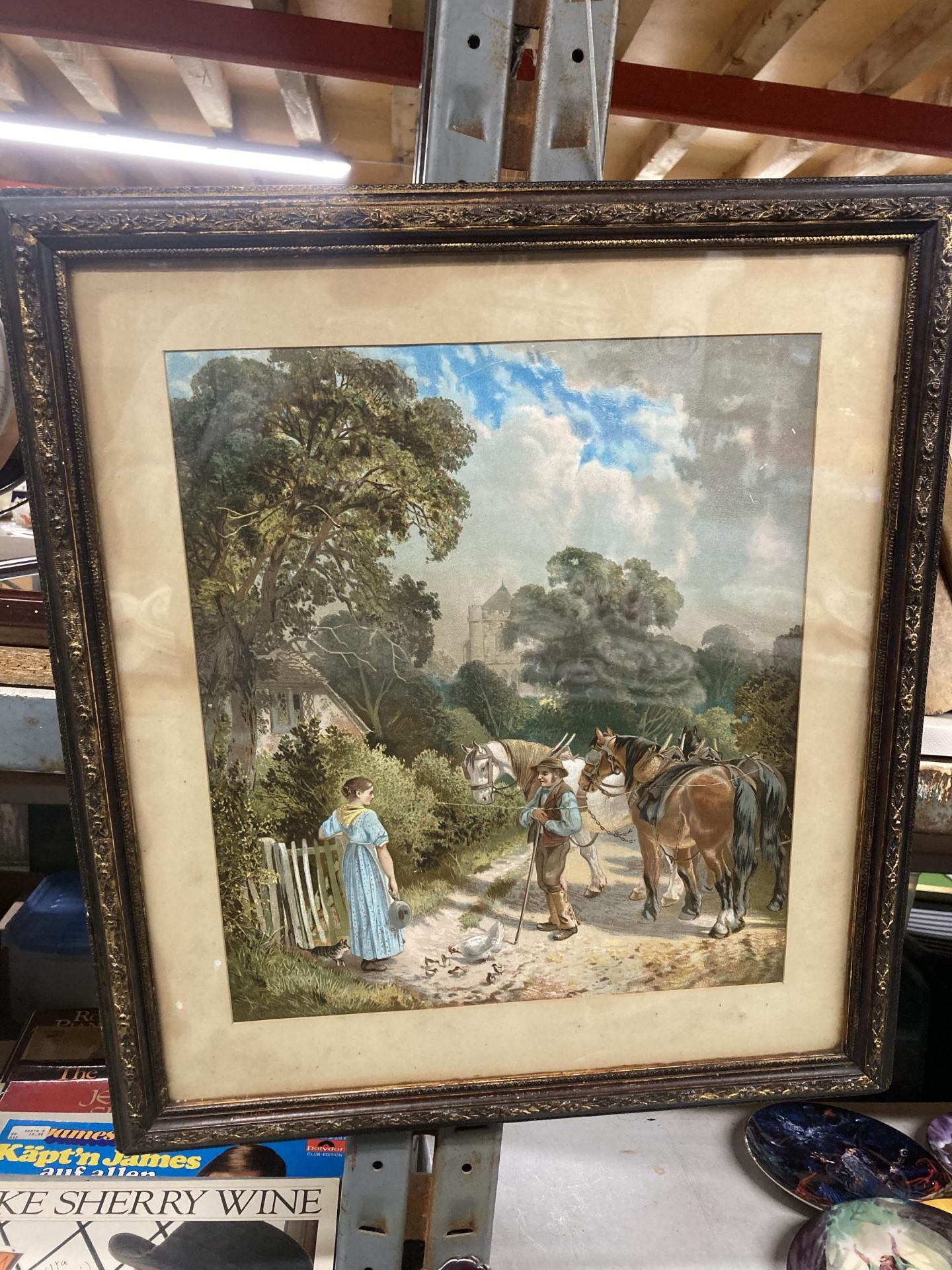 A FRAMED PRINT OF A COUNTRYSIDE SCENE