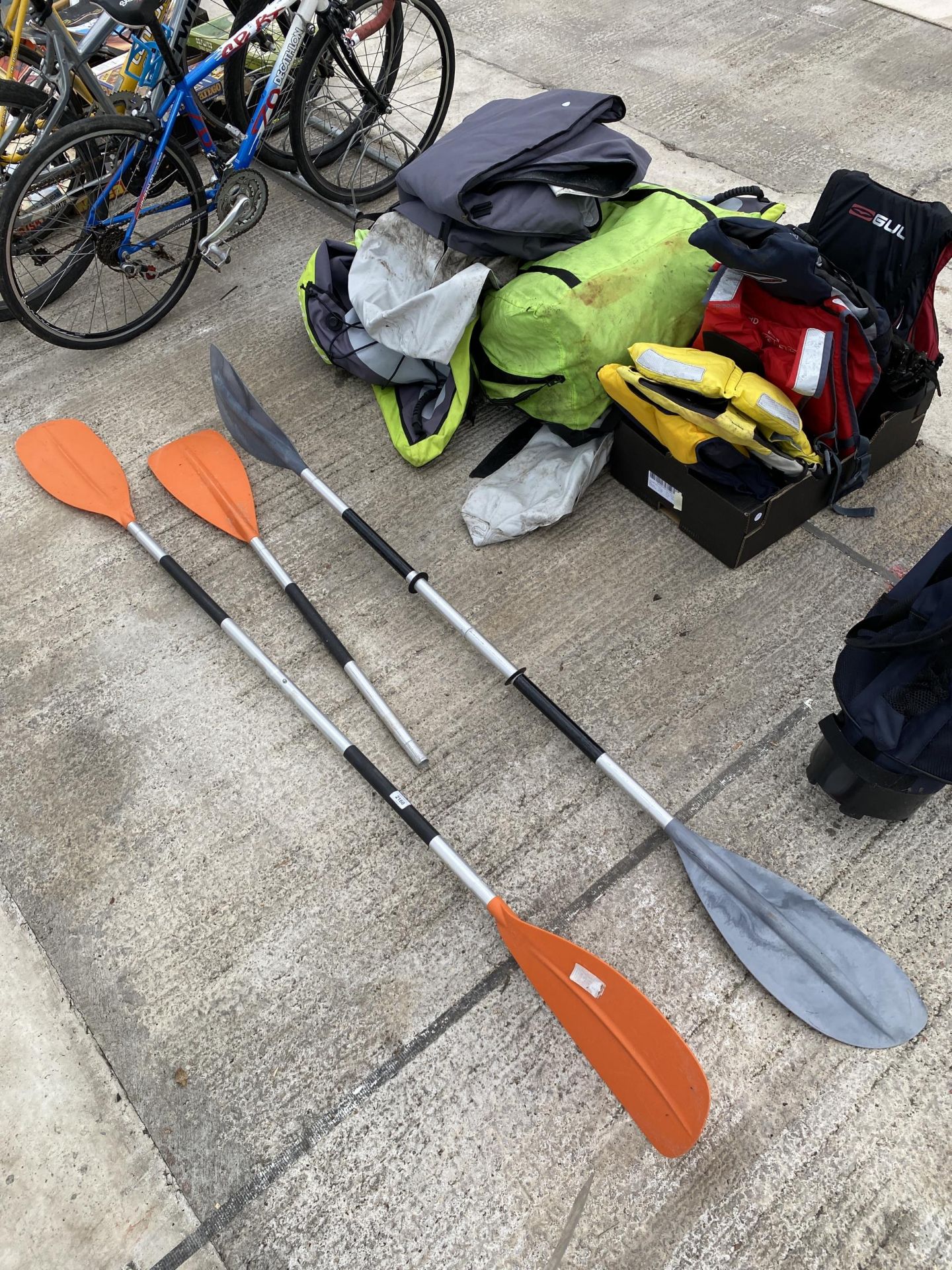 A LARGE QUANTITY OF KAYAKING EQUIPMENT TO INCLUDE LIFE JACKETS AND ORES ETC