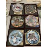 A GROUP OF SIX BOXED A FAMILY CHRISTMAS CABINET PLATES
