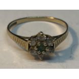 A 9 CARAT GOLD RING WITH CENTRE EMERALD SURROUNDED BY CUBIC ZIRCONIAS SIZE O