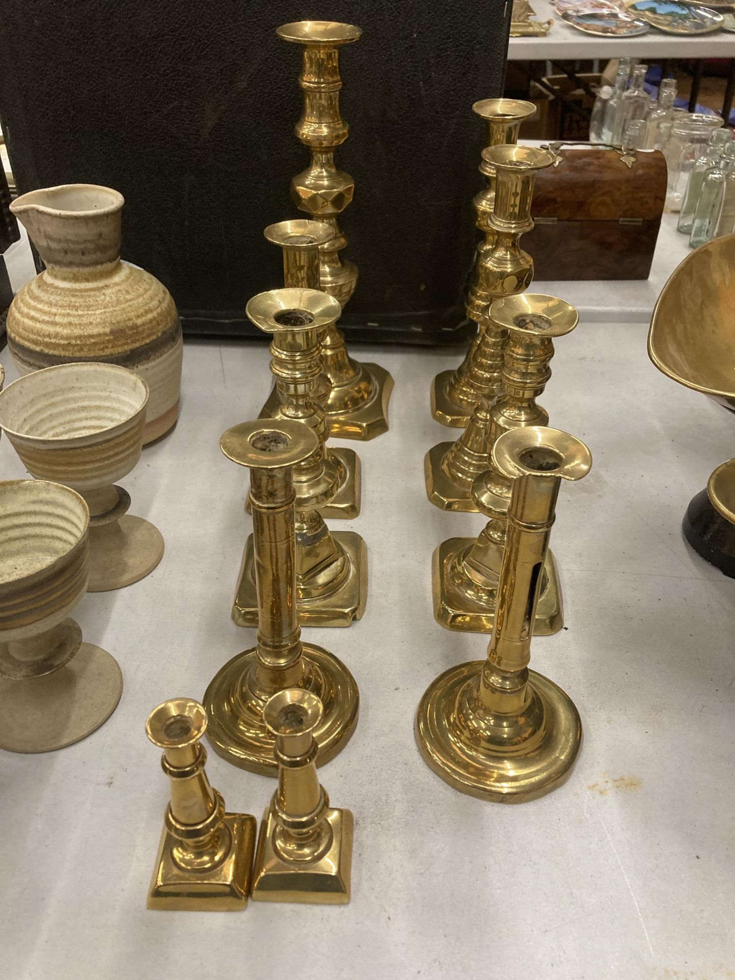 A COLLECTION OF TEN ASSORTED VINTAGE BRASS CANDLESTICKS