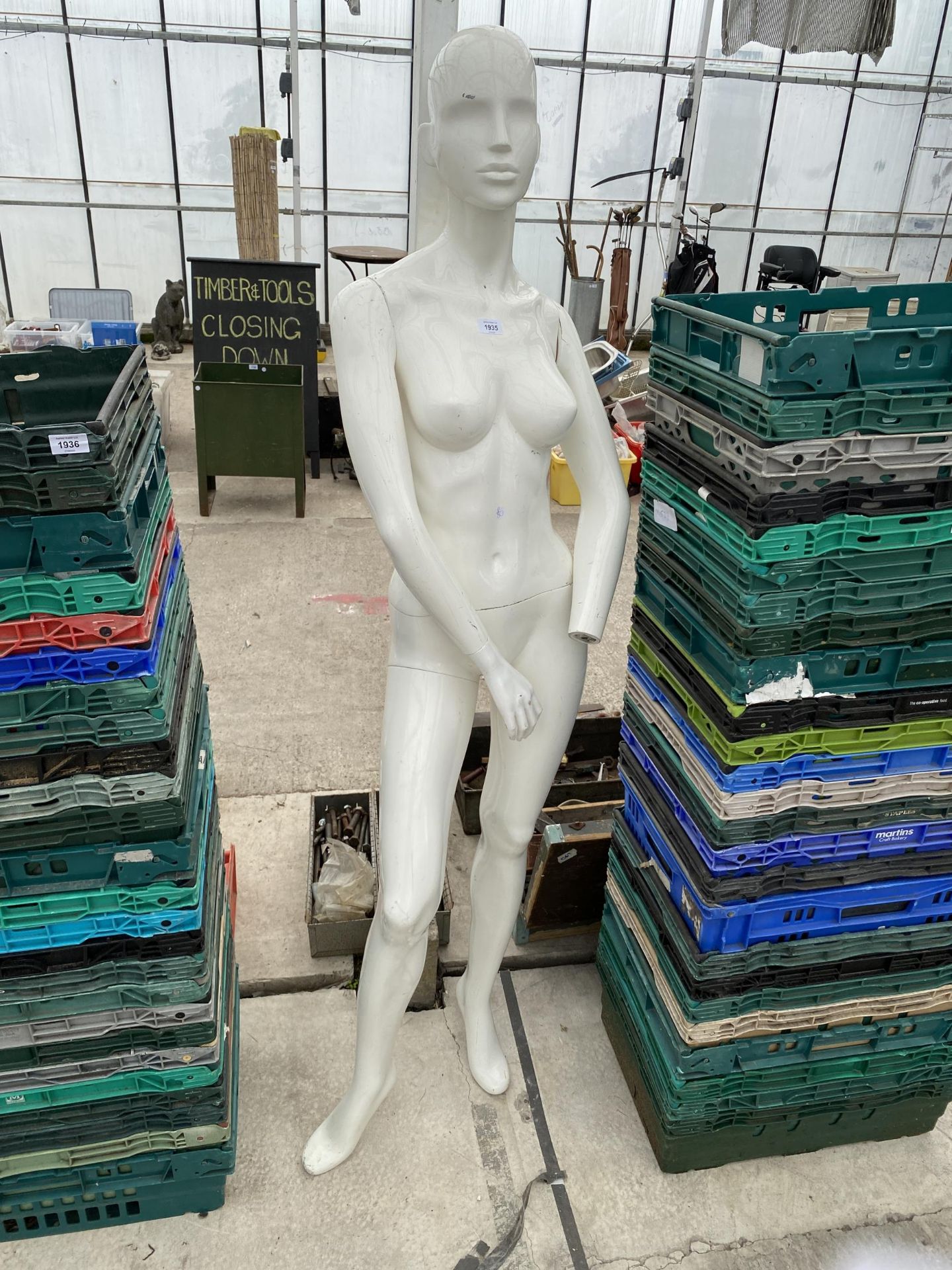 A FEMALE LIFE SIZE MANNEQUIN MISSING A HAND