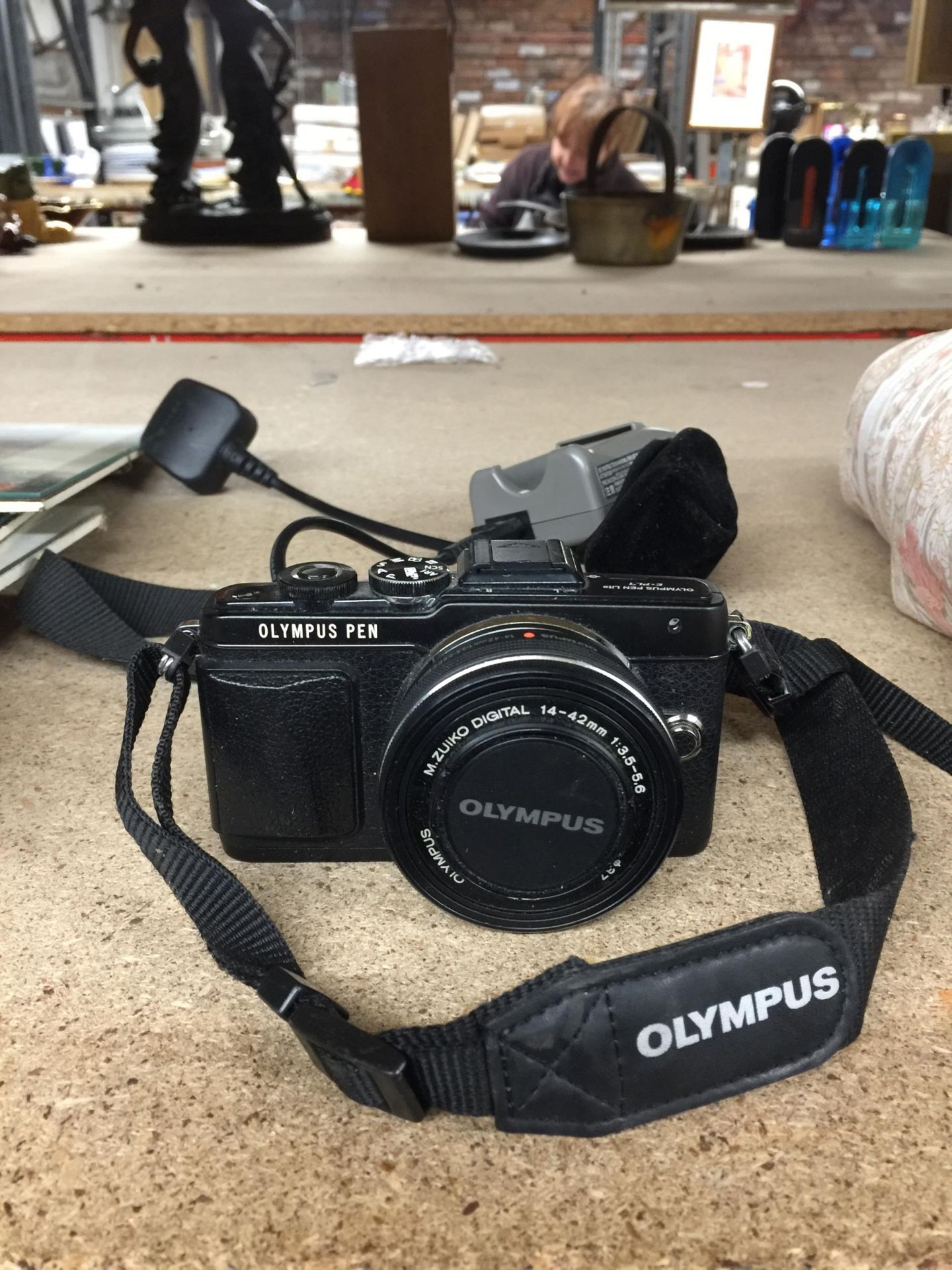 A DIGITAL OLYMPUS CAMERA WITH CHARGER