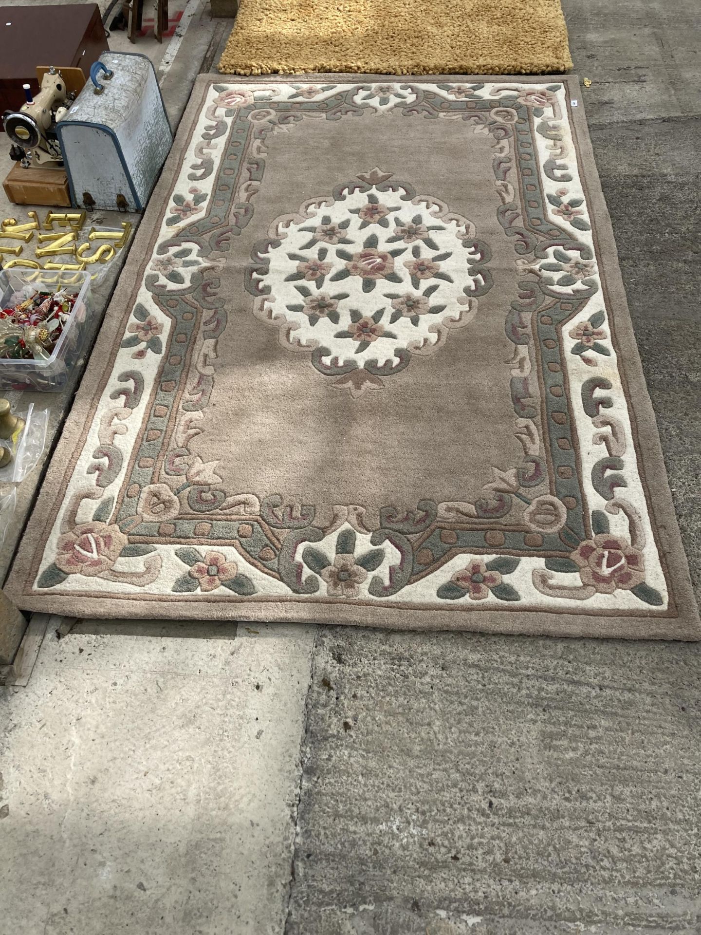 A LARGE PINK AND CREAM PATTERNED RUG