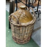 A LARGE F T MORRELL & CO 105-107 GT ANCOATS STREET MANCHESTER STONEWARE VESSEL IN A WICKER BASKET