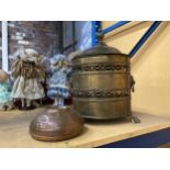 A LARGE BRASS LIDDED COAL BUCKET WITH LIONS HEAD HANDLES PLUS A COPPER FOOT WARMER