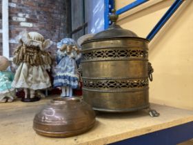 A LARGE BRASS LIDDED COAL BUCKET WITH LIONS HEAD HANDLES PLUS A COPPER FOOT WARMER