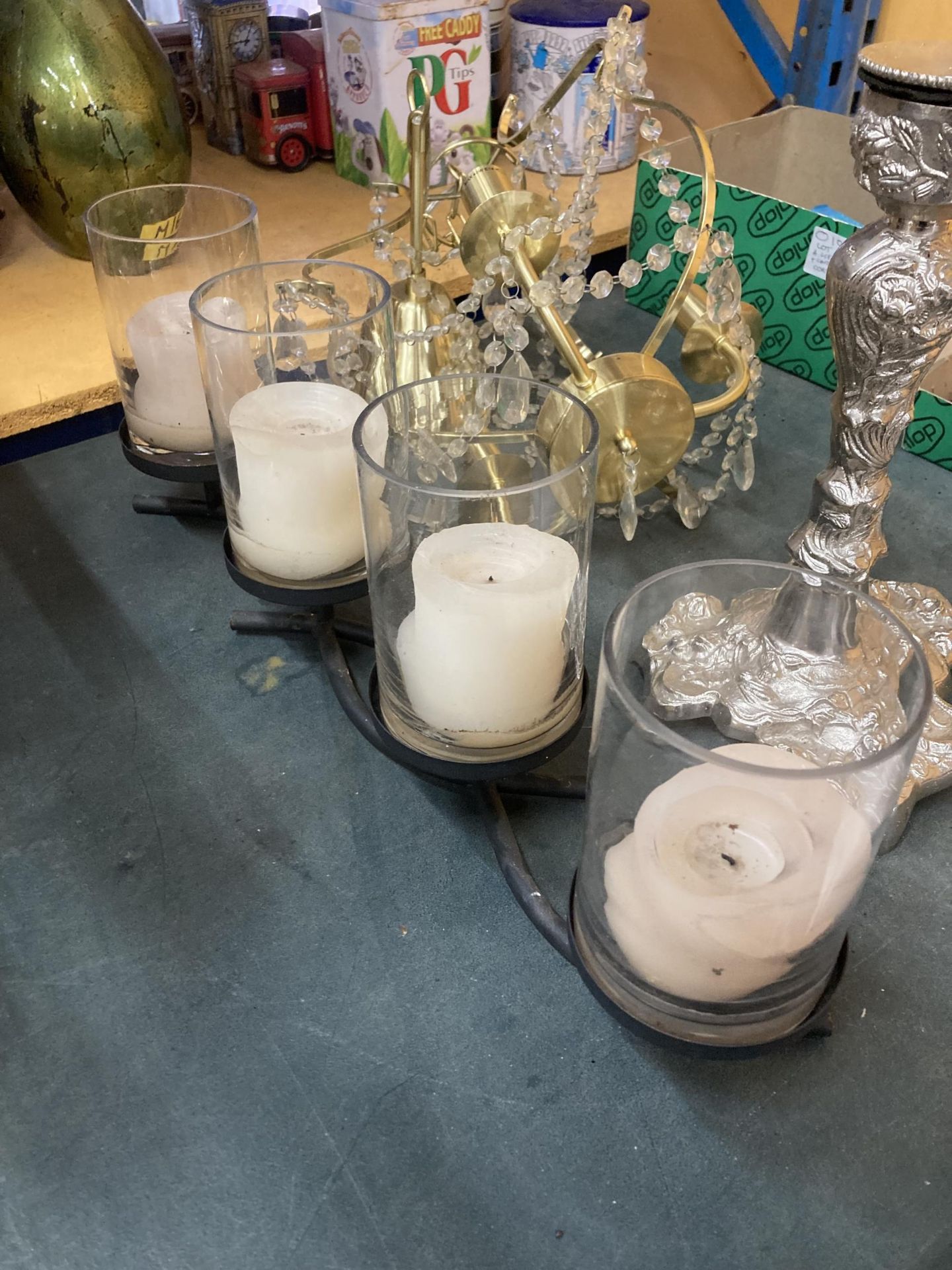 A LARGE METAL CANDLE HOLDER HOLDING FOUR LARGE CANDLES IN GLASS HOLDERS, A LARGE SILVER COLOURED - Image 5 of 5