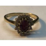 A 9 CARAT GOLD RING WITH CENTRE AMETHYST SURROUNDED BY CUBIC ZIRCONIAS SIZE N/O