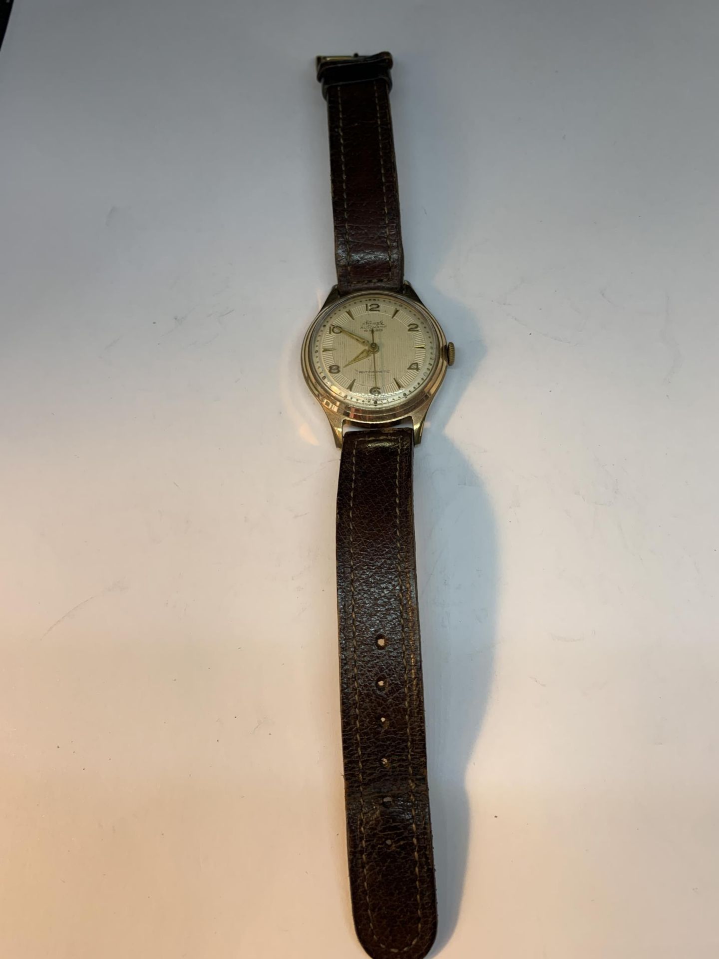A VINTAGE KIENZLE AUTOMATIC 19 RUBIS ANTIMAGNETIC WRIST WATCH WITH BROWN LEATHER STRAP SEEN