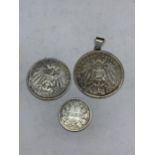 THREE 900 SILVER COINS ONE MADE IN TO A PENDANT GROSS WEIGHT 50.6 GRAMS