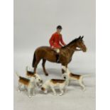 A BESWICK HUNTSMAN ON BROWN HORSE STANDING BROWN GLOSS WITH FOUR HOUNDS