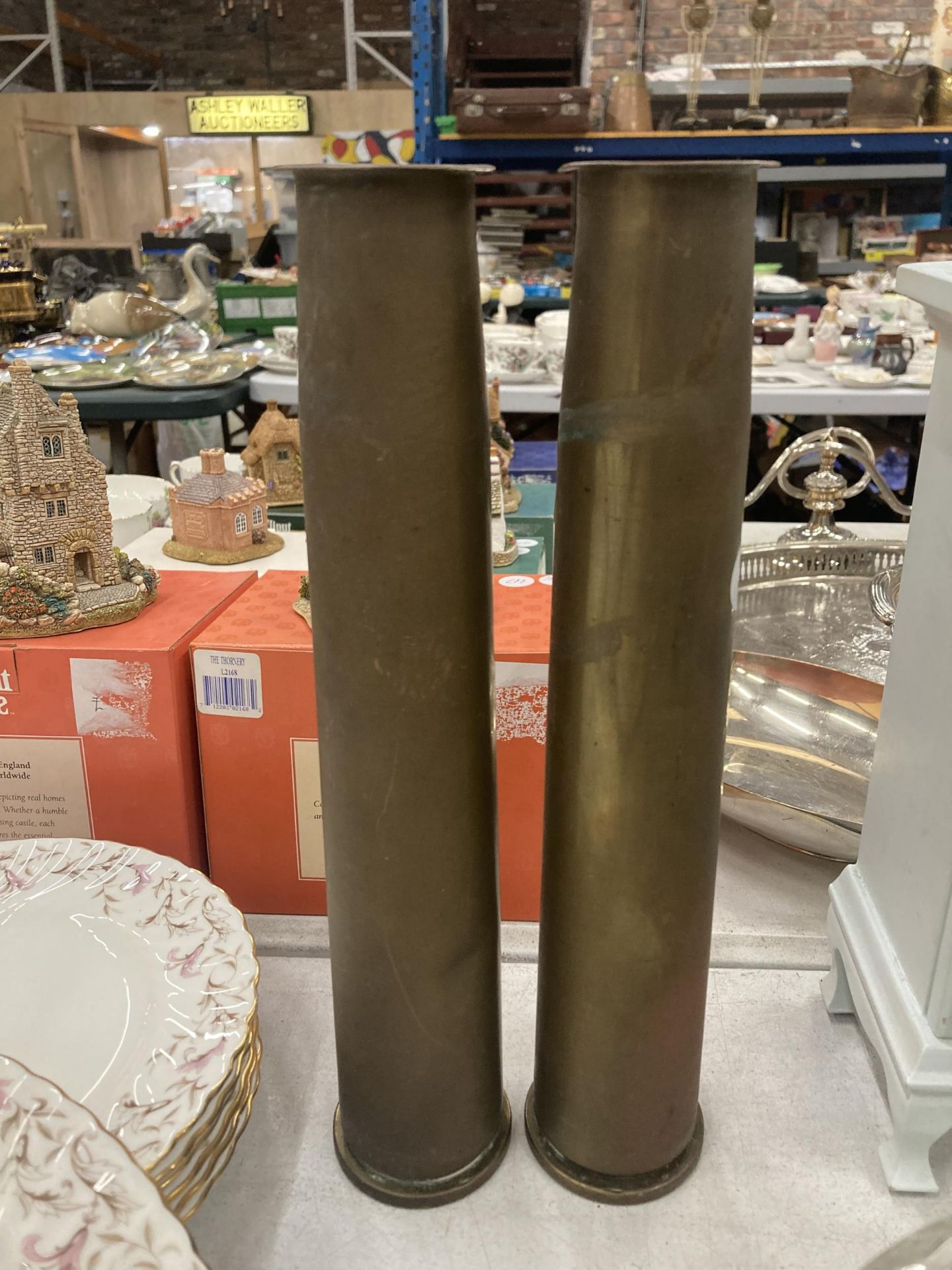 A PAIR OF TALL TRENCH ART SHELL VASES, DATED 1951