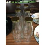 SIX GLASS LIDDED PINT BOTTLES