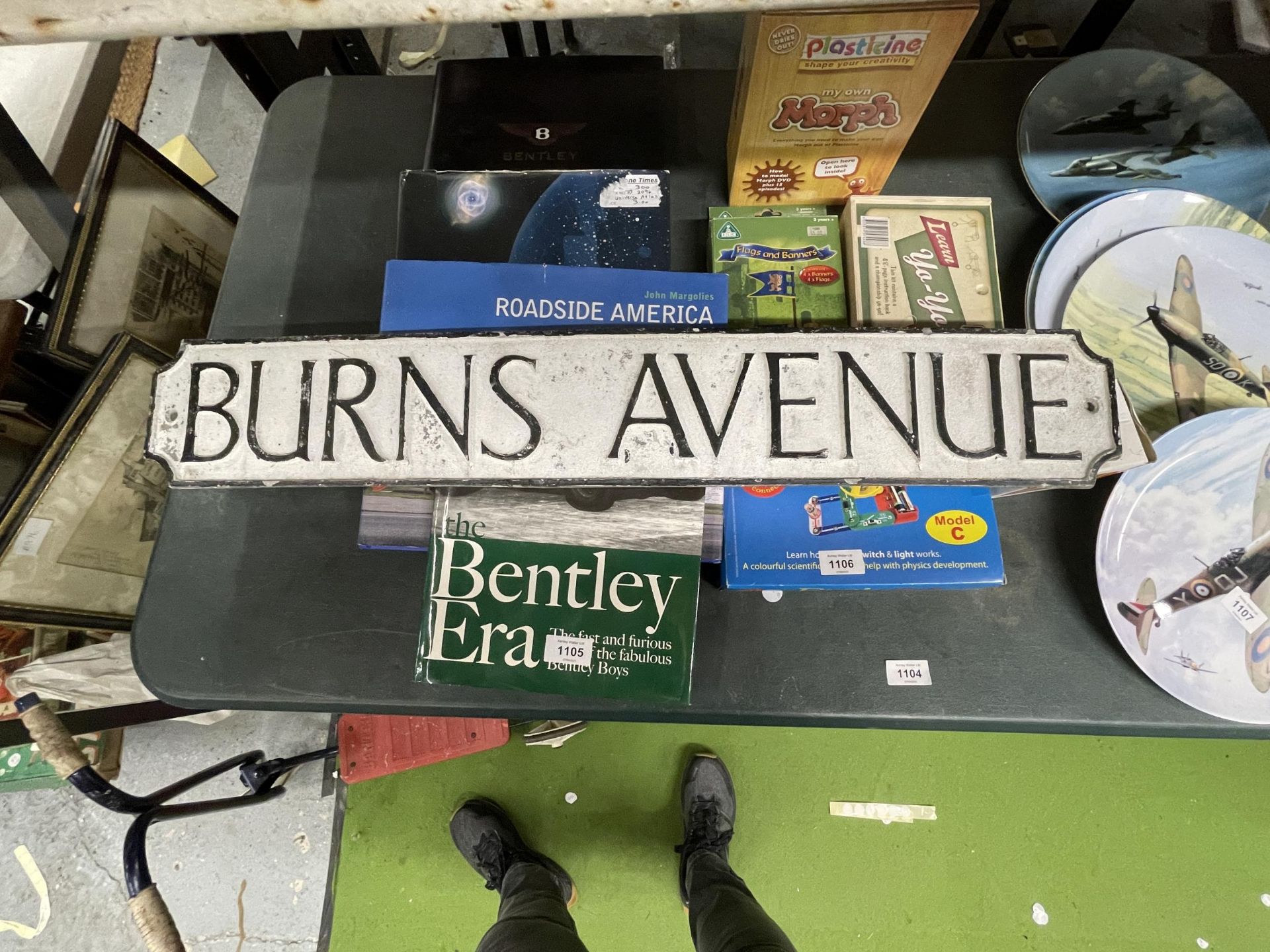 A METAL 'BURNS AVENUE' SIGN 83CM X 13CM