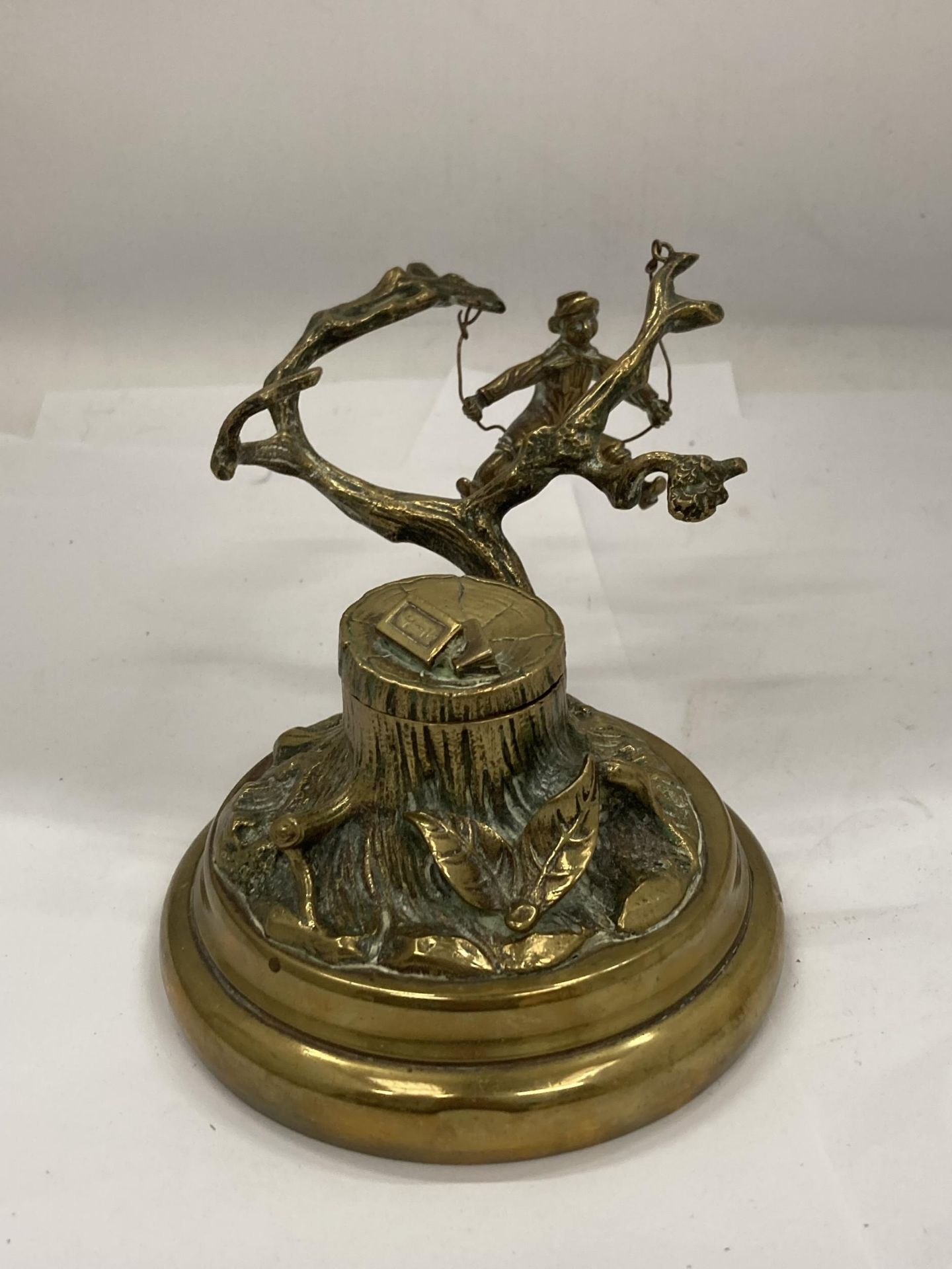 A VINTAGE NOVELTY BRASS INKWELL WITH A SINGING BOY IN A TREE