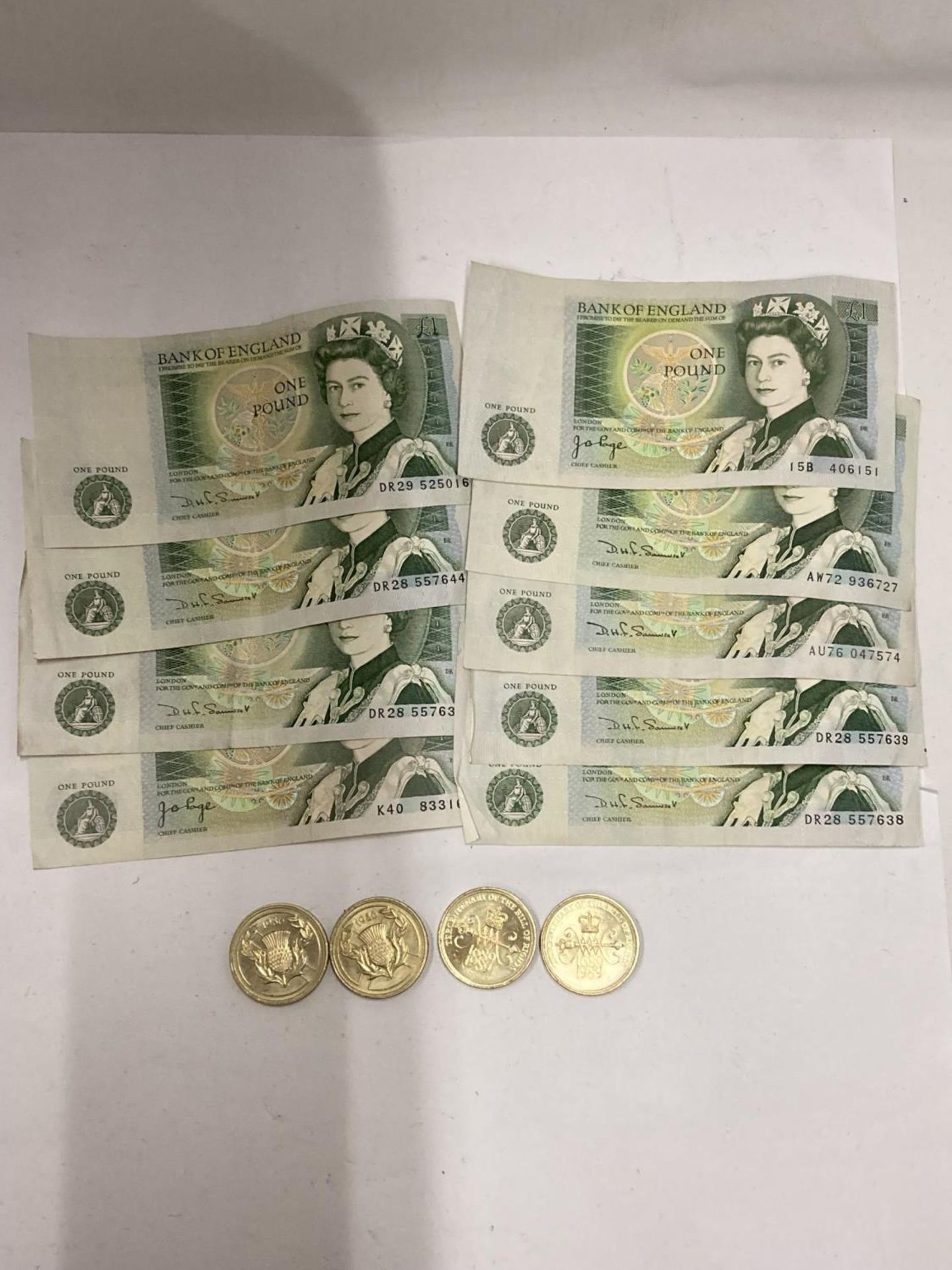 NINE ONE POUND NOTES AND FOUR TWO POUND COINS