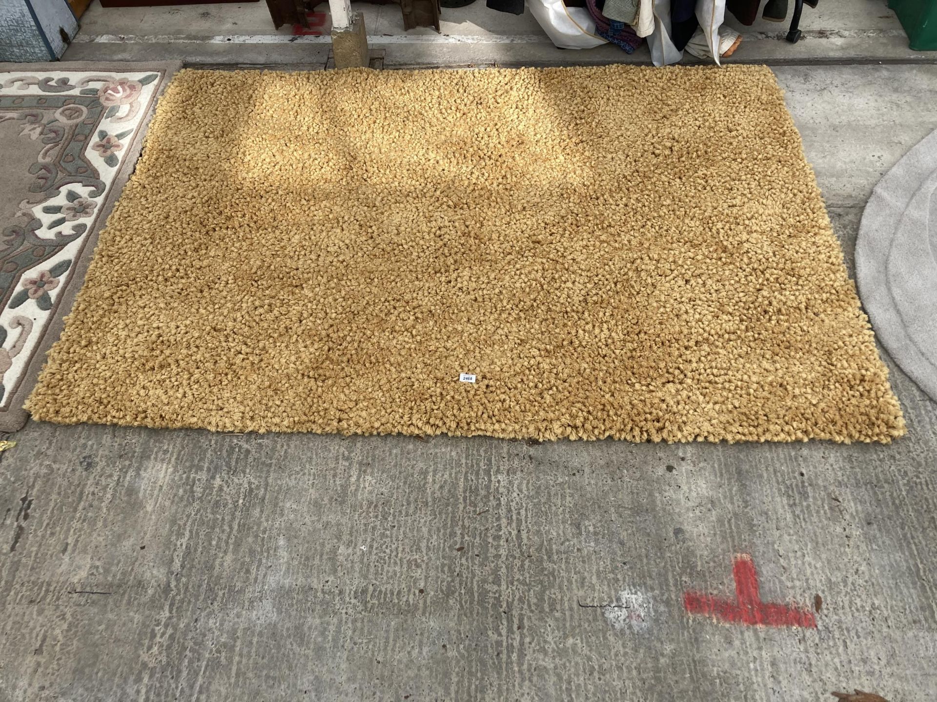 A LARGE YELLOW SHAGGY RUG