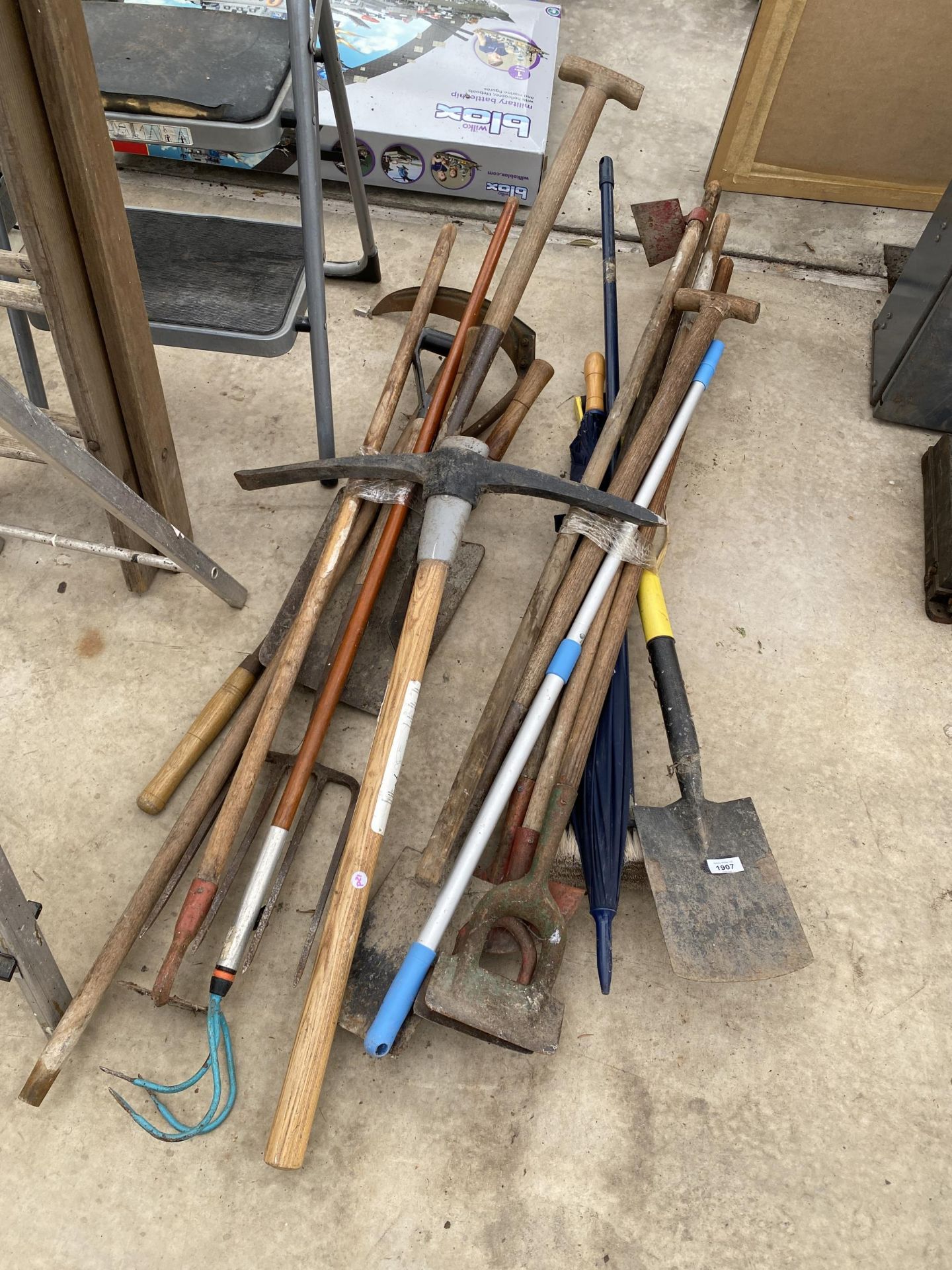 AN ASSORTMENT OF GARDEN TOOLS TO INCLUDE SPADES, FORKS AND HOES ETC