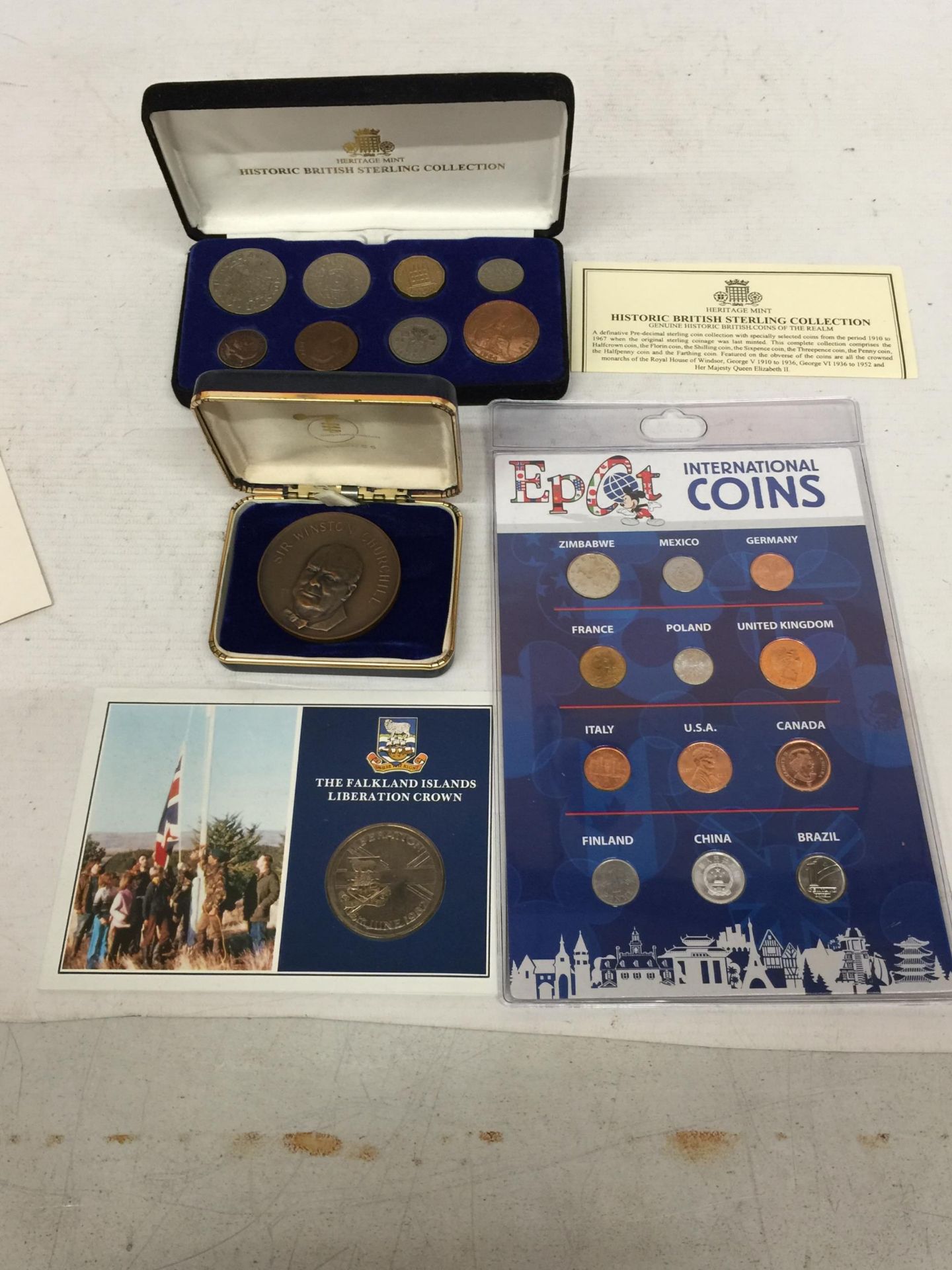 A CASED HISTORIC BRITISH STERLING COLLECTION, A CHURCHILL MEDAL, FALKLANDS ISLAND CROWN AND AN EPCOT