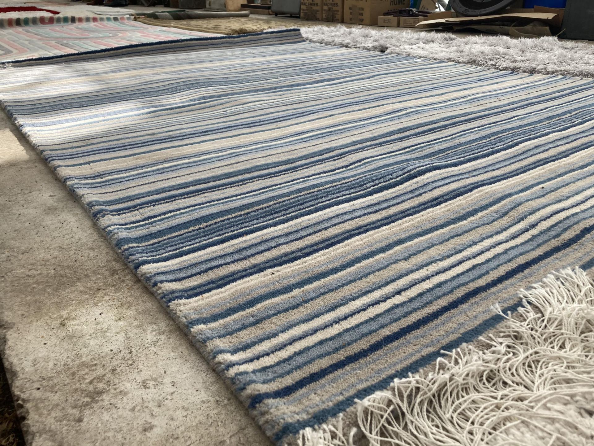 A LARGE BLUE STRIPPED RUG - Image 2 of 2