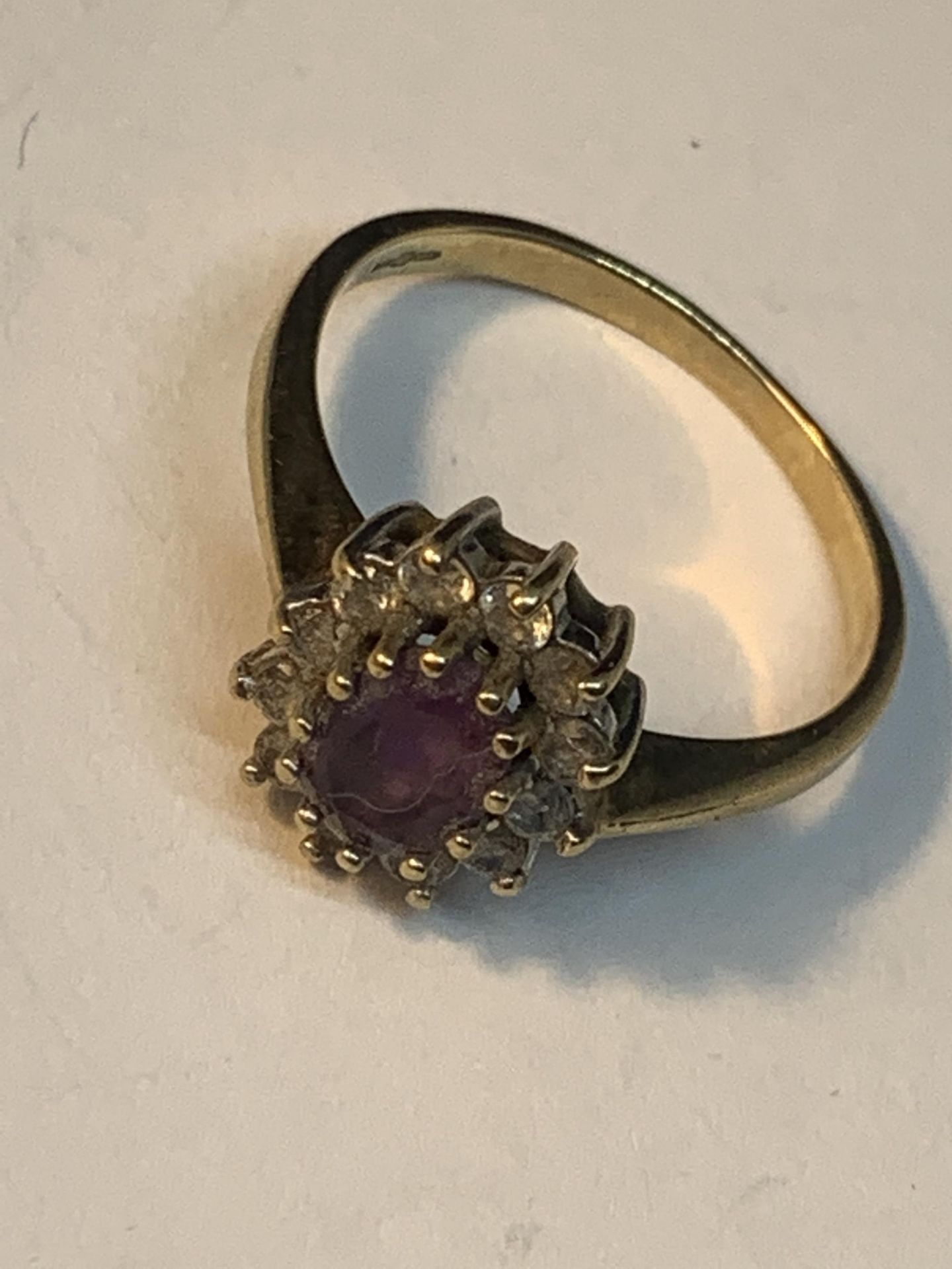 A 9 CARAT GOLD RING WITH CENTRE AMETHYST SURROUNDED BY CUBIC ZIRCONIAS SIZE N/O - Image 4 of 4