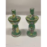 A PAIR OF VINTAGE ENAMELLED CANDLESTICKS, HEIGHT 18CM - 1 A/F TO THE BASE