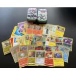 TWO TINS OF ASSORTED POKEMON CARDS, HOLOS ETC