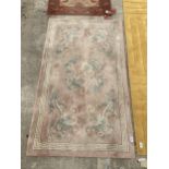 A SMALL ORIENTAL STYLE RUG WITH DRAGON DESIGN