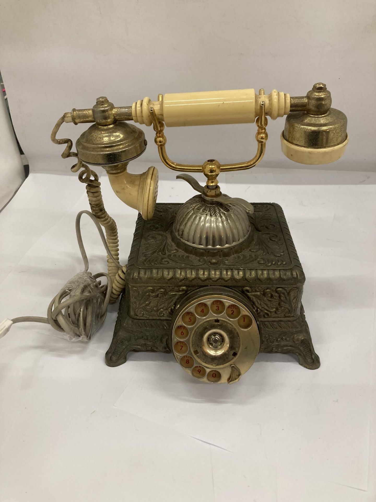 A HEAVY VINTAGE BRASS ORNATE TELEPHONE