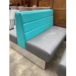 A MODERN DOUBLE SIDED BOOTH SEATING IN TURQUOISE AND GREY