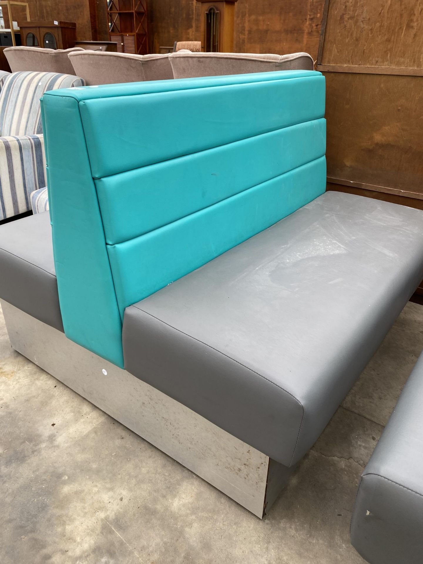 A MODERN DOUBLE SIDED BOOTH SEATING IN TURQUOISE AND GREY