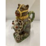 A MAJOLICA STYLE BEAR JUG DEPICTING A CHAINED BEAR HOLDING A DOG, DOGS ARM A/F