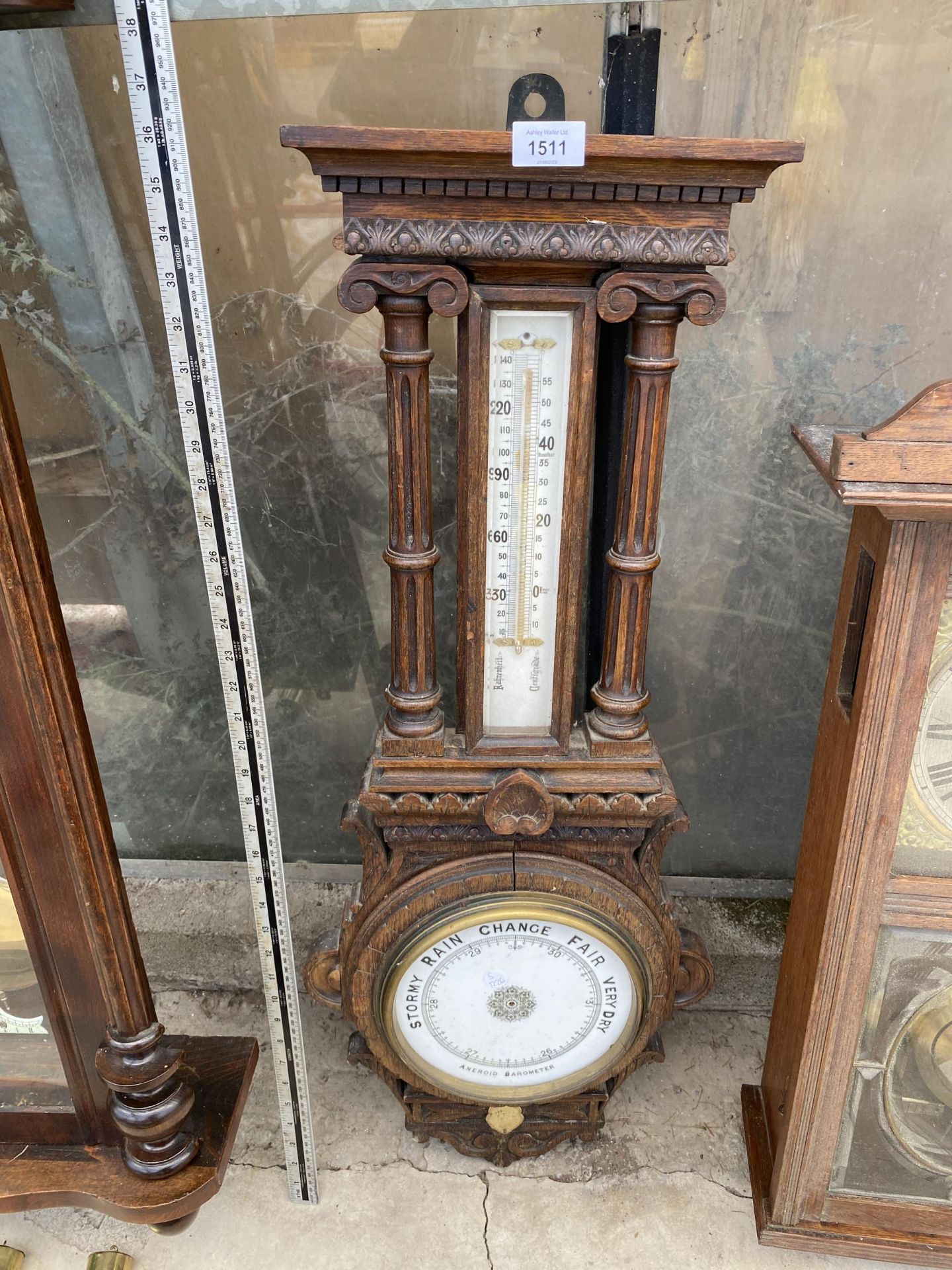 A DECORATIVE OAK CASED ANEROID BAROMETER