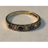 A 9 CARAT GOLD RING WITH FOUR SAPPHIRES AND THREE CUBIC ZIRCONIAS IN A LINE SIZE J/K